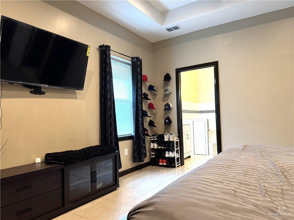 6105 South Mars Lane Pharr, TX 78577 - Photo 29 of 45 a bed room with a bed and a television