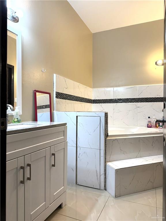 6105 South Mars Lane Pharr, TX 78577 - Photo 30 of 45 a bathroom with a sink and a mirror