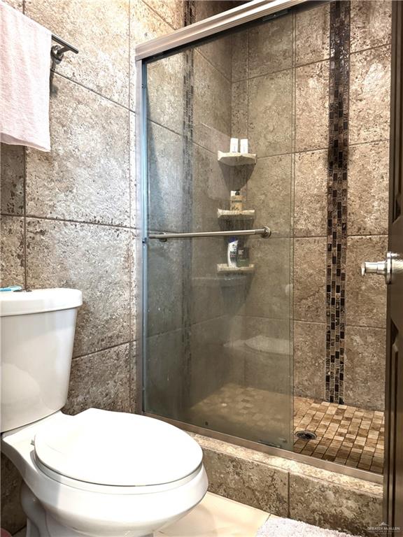 6105 South Mars Lane Pharr, TX 78577 - Photo 31 of 45 a bathroom with a toilet and a shower