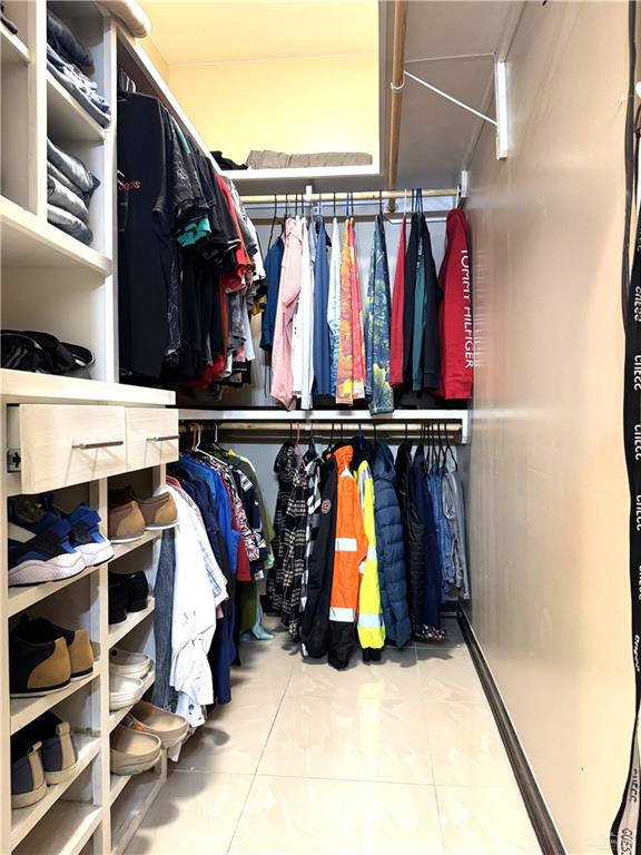 6105 South Mars Lane Pharr, TX 78577 - Photo 32 of 45 a view of walk in closet with clothes and shoes