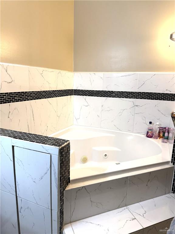 6105 South Mars Lane Pharr, TX 78577 - Photo 33 of 45 a bathroom with a bathtub and a sink