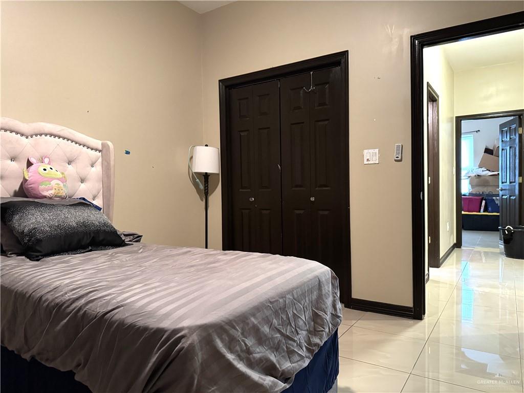 6105 South Mars Lane Pharr, TX 78577 - Photo 38 of 45 a bedroom with a bed and a closet