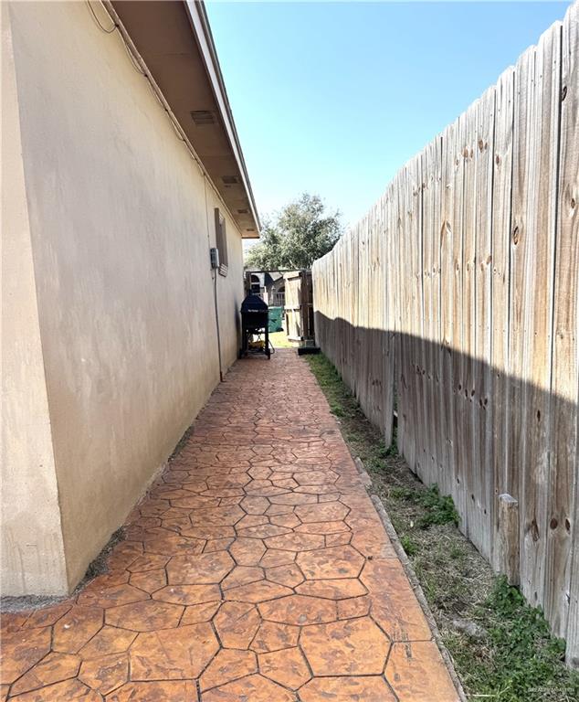 6105 South Mars Lane Pharr, TX 78577 - Photo 9 of 45 a view of a pathway with a wooden fence