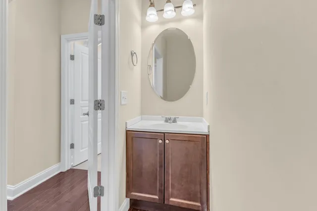 a bathroom with a granite countertop sink a mirror and a vanity