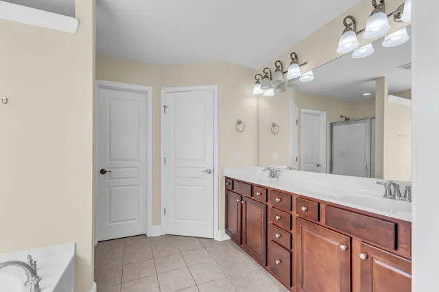 a spacious bathroom with a double vanity sink and a mirror