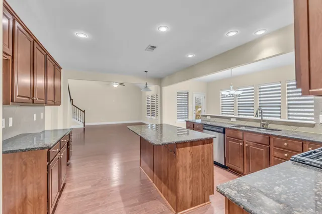 a kitchen with lots of counter space and windows