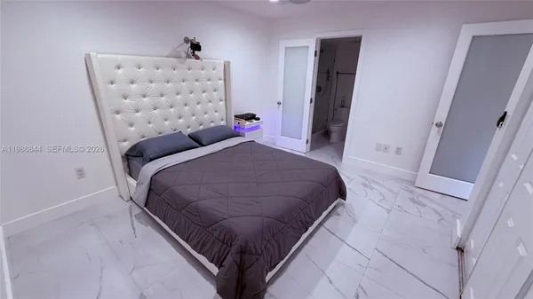 a bedroom with a bed and a couch