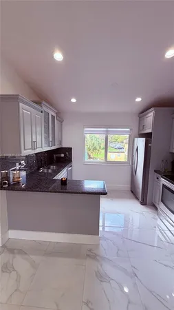 a view of a kitchen with a sink and dishwasher