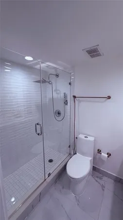 a bathroom with a shower a toilet and a sink