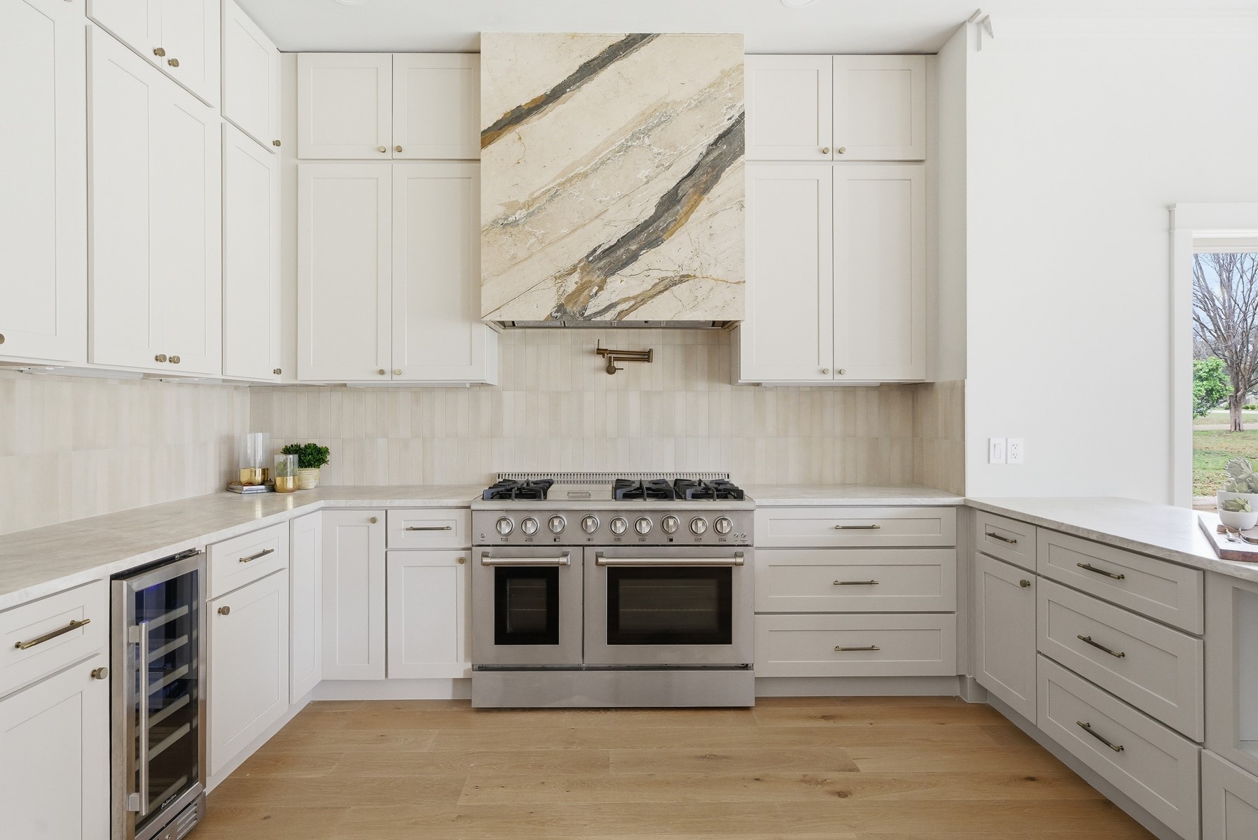 10259 Brangus Road Driftwood, TX 78619 - Photo 11 of 39 a kitchen with stainless steel appliances granite countertop a stove and a white cabinets