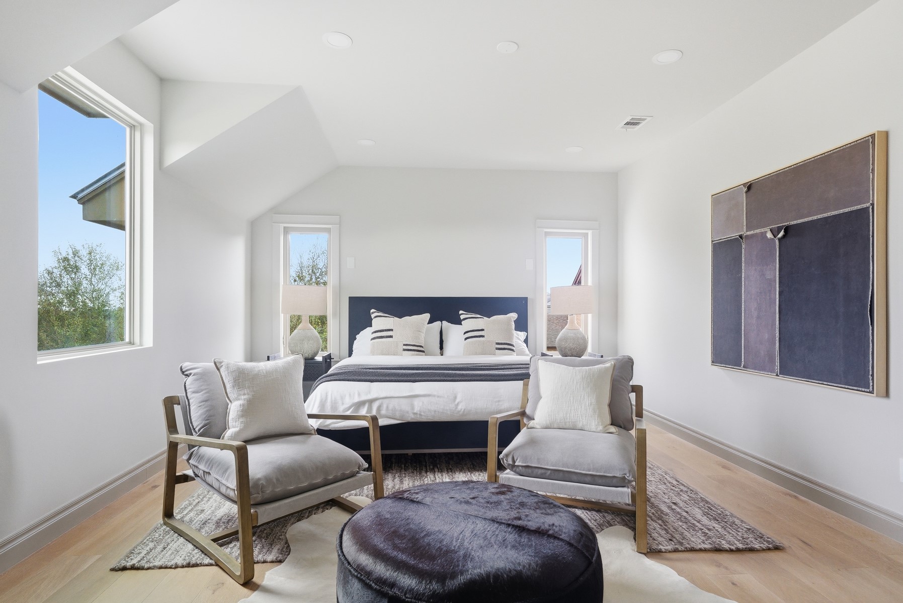 10259 Brangus Road Driftwood, TX 78619 - Photo 27 of 39 a spacious bedroom with a bed and a couch