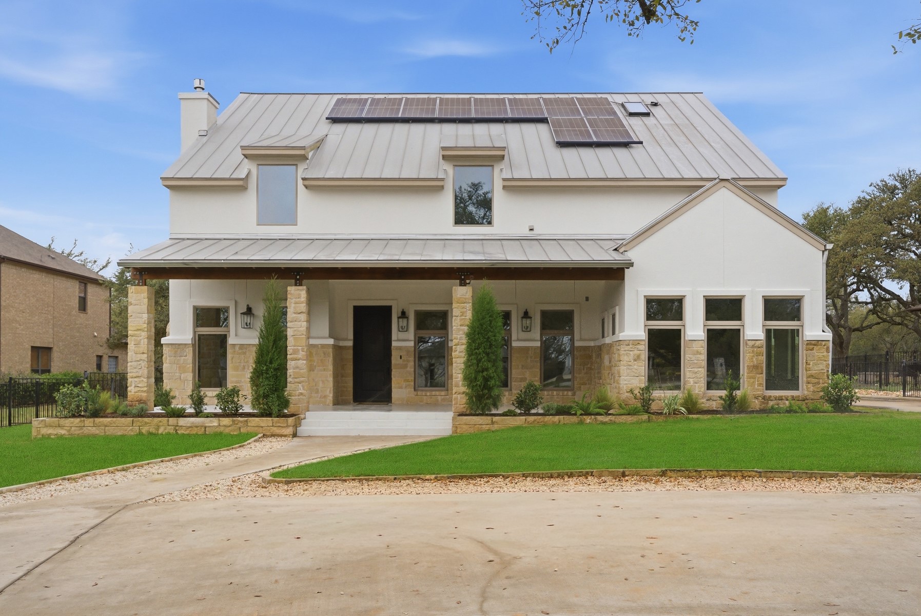 10259 Brangus Road Driftwood, TX 78619 - Photo 3 of 39 front view of a brick house with a yard