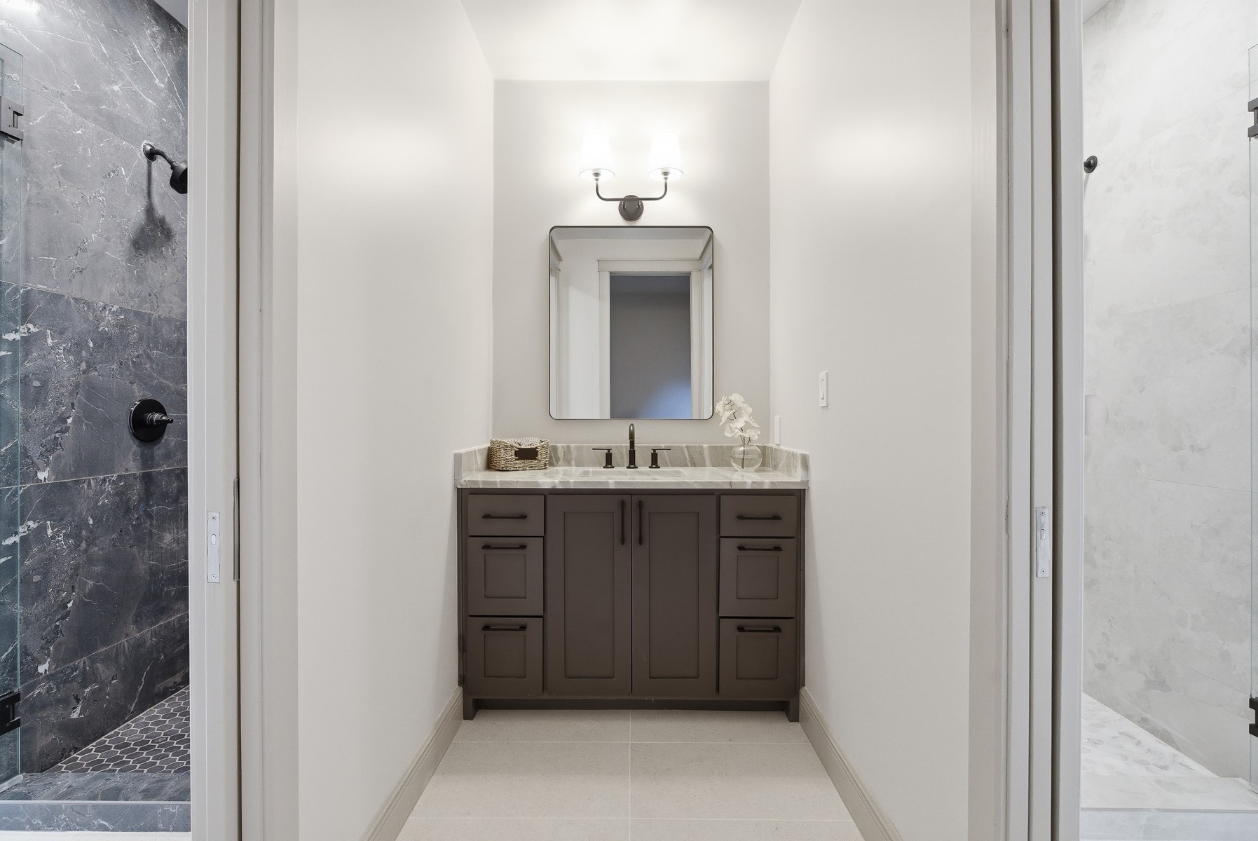 10259 Brangus Road Driftwood, TX 78619 - Photo 35 of 39 a bathroom with a sink and a mirror