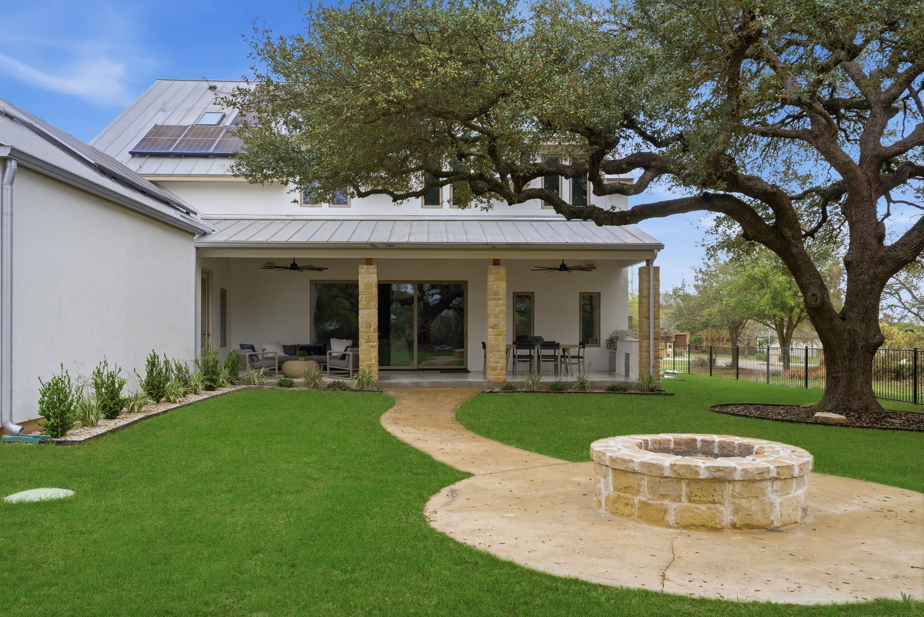 10259 Brangus Road Driftwood, TX 78619 - Photo 37 of 39 a view of a house with backyard sitting area and garden