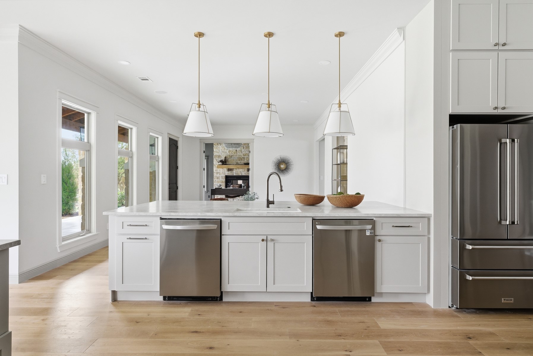 10259 Brangus Road Driftwood, TX 78619 - Photo 10 of 39 a kitchen with kitchen island a sink a stove and refrigerator