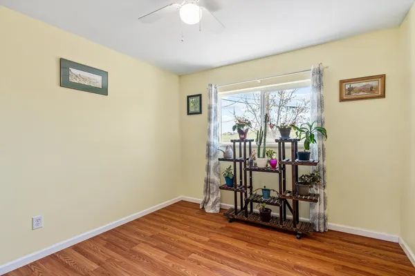 a view of a room with wooden floor and windows