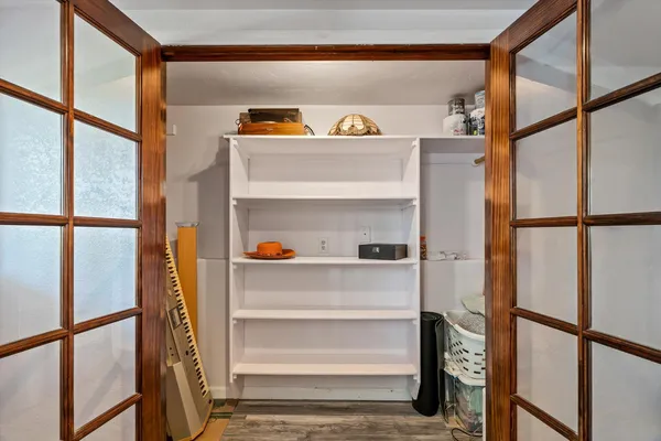 a view of walk in closet with clothes and shoes