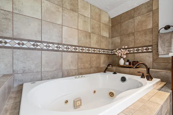 a bathroom with a tub and a shower
