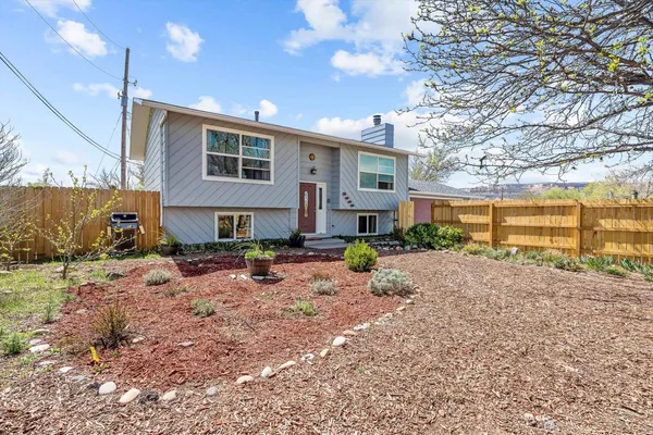 a front view of a house with a yard and outdoor seating