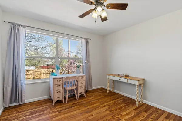 a workspace with wooden floor and a window