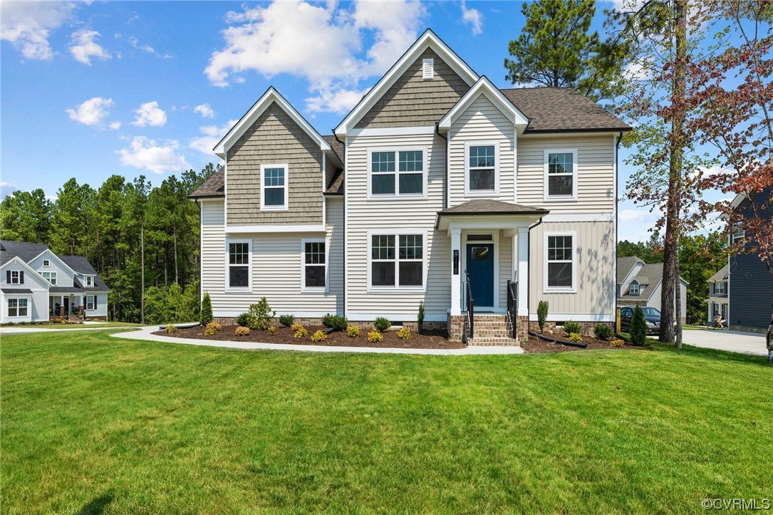 a front view of a house with a yard and trees