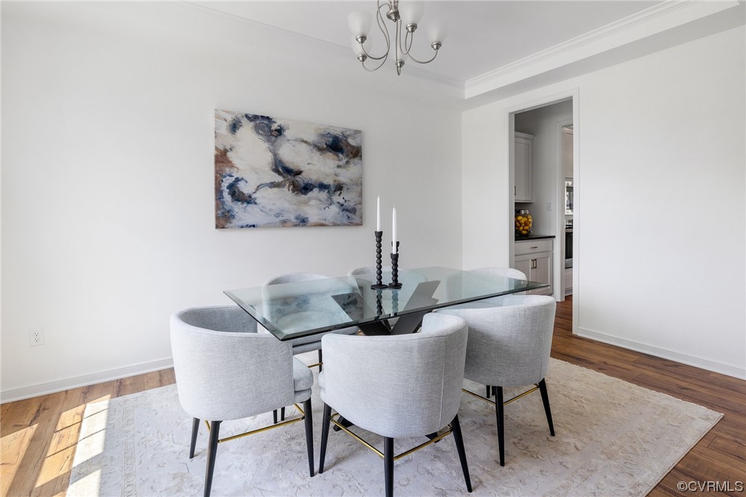 9118 Copplestone Road Chesterfield, VA 23832 - Photo 11 of 48 a view of a dining room with furniture and wooden floor