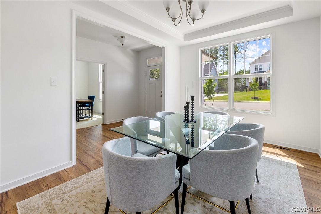 9118 Copplestone Road Chesterfield, VA 23832 - Photo 13 of 48 a dining room with furniture a rug and wooden floor