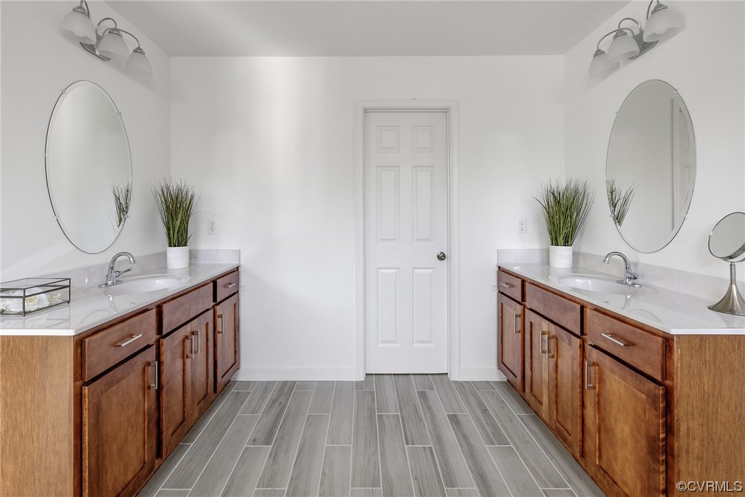 9118 Copplestone Road Chesterfield, VA 23832 - Photo 35 of 48 a bathroom with a double vanity sink and a mirror