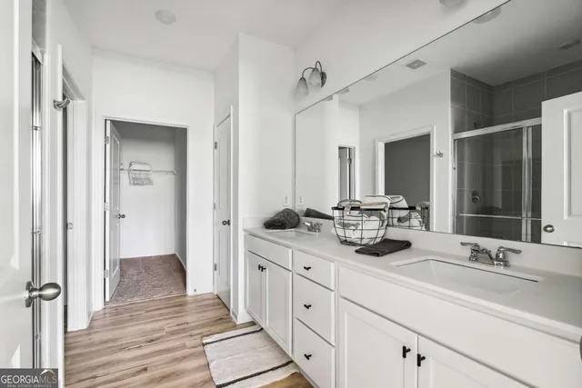 a bathroom with a double vanity sink and mirror