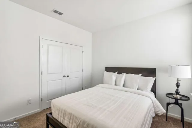 a bedroom with a bed and a table