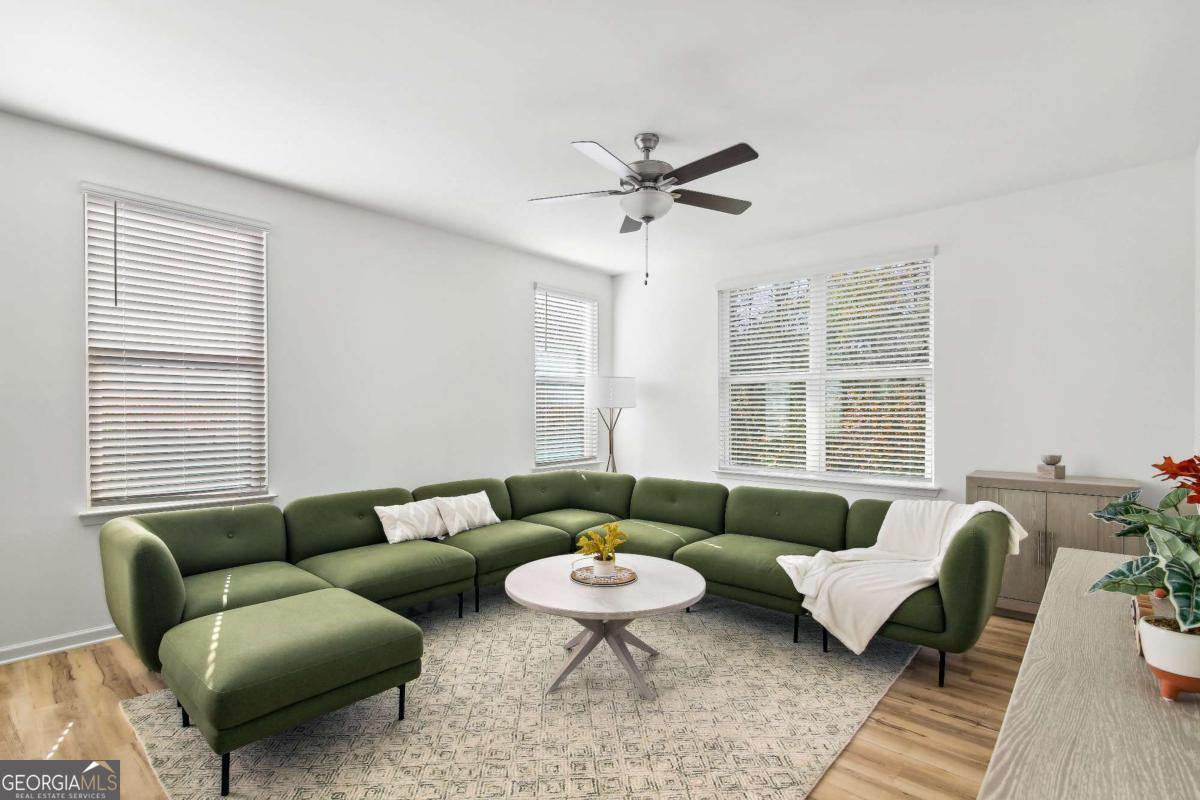 1517 Salinger Court, Unit 1517 Stockbridge, GA 30281 - Photo 5 of 26 a living room with furniture and a large window