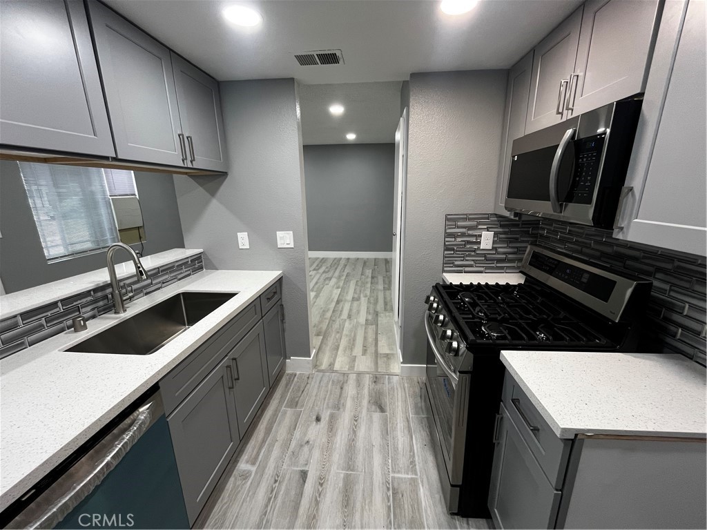 2405 Tahoe Circle, Unit B Hemet, CA 92545 - Photo 4 of 12 a kitchen with a sink stove and cabinets