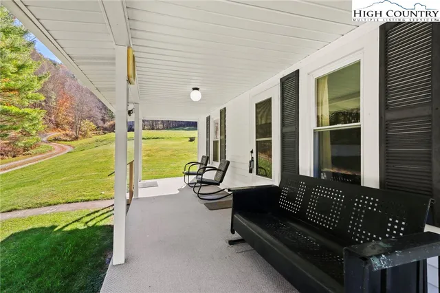 a building outdoor space with patio the couches and potted plants with sky view