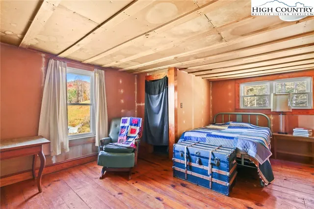 a bedroom with furniture and a window