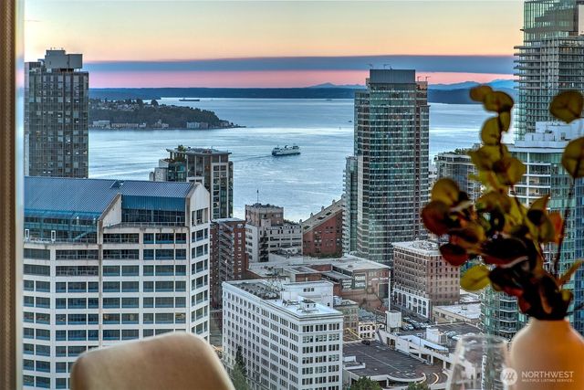 a view of a balcony with two chairs and a potted plant