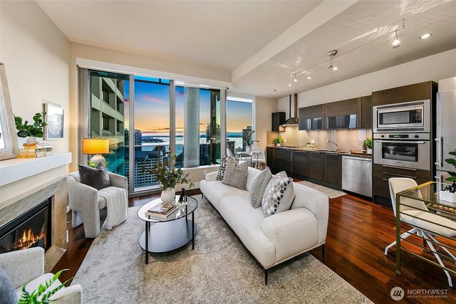 a living room with furniture fireplace and a table