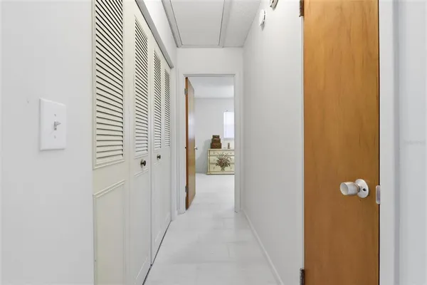 a view of a hallway with wooden shelves