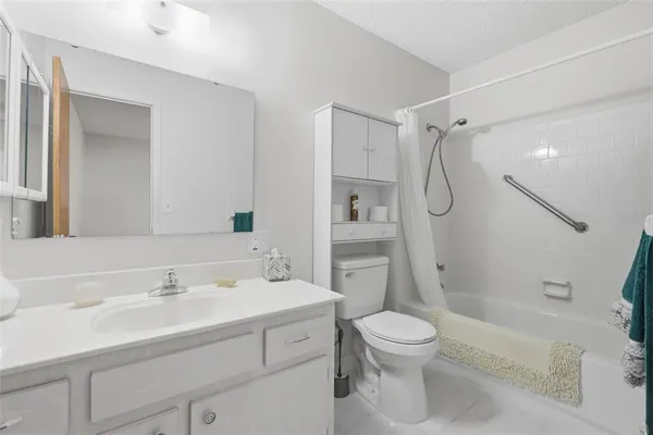 a bathroom with a sink toilet tub and shower
