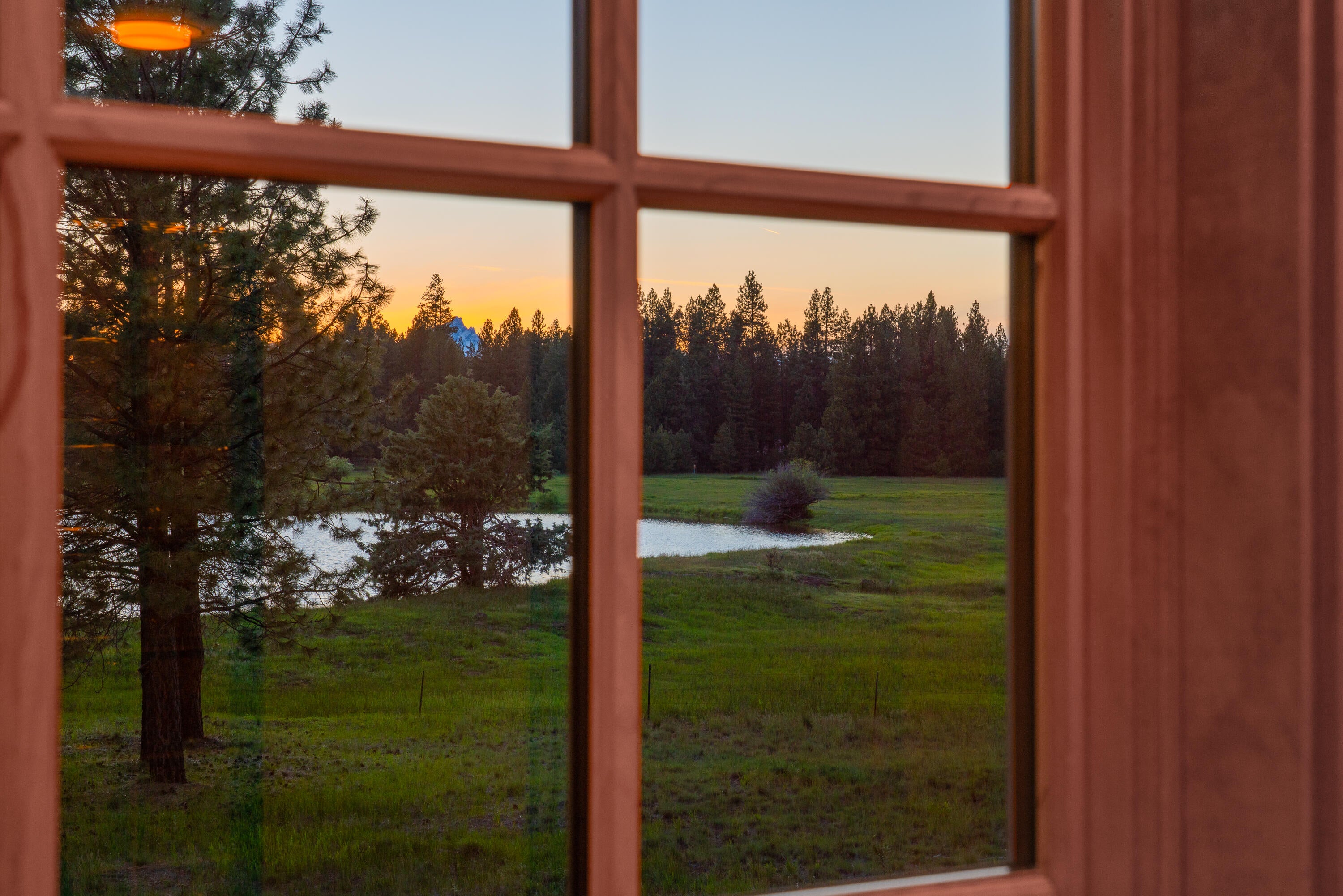 70331 Willow Herb, Unit GM205 Black Butte Ranch, OR 97759 - Photo 55 of 75 A twilight/sunset view from the upstairs bathroom of lake, meadow and the pinnacles of Three Fingered Jack