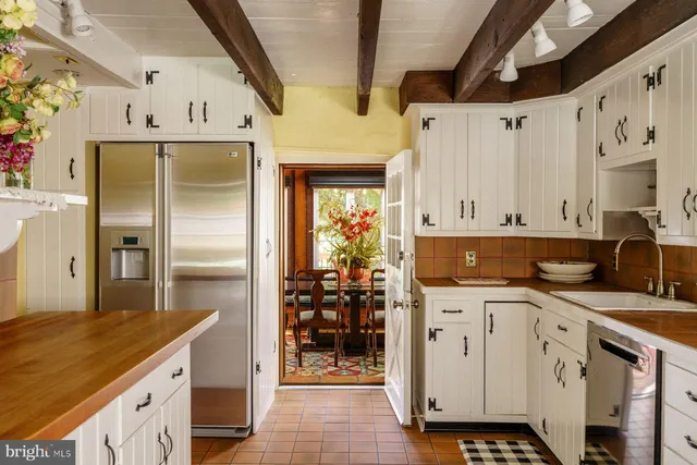a kitchen with stainless steel appliances a refrigerator sink and cabinets