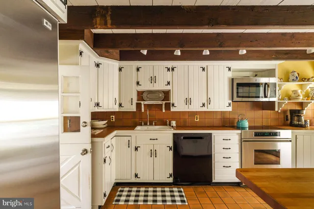 a kitchen with stainless steel appliances granite countertop a stove and a refrigerator