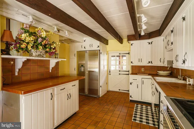 a kitchen with stainless steel appliances a stove a sink and a refrigerator