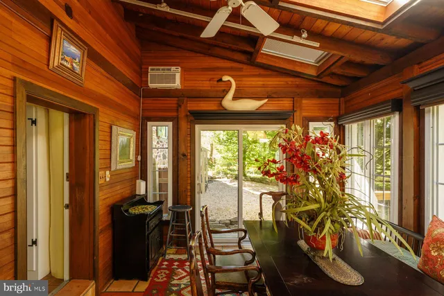 a view of a porch with furniture and floor to ceiling window
