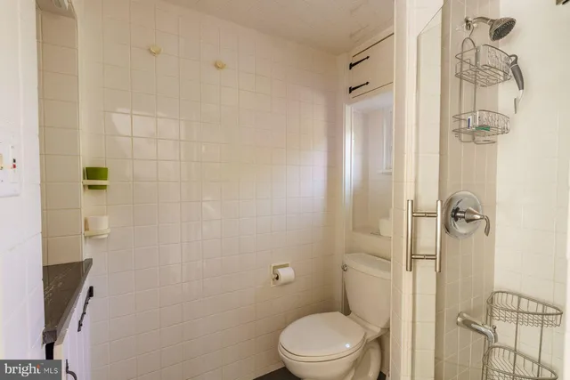 a bathroom with a toilet and shower