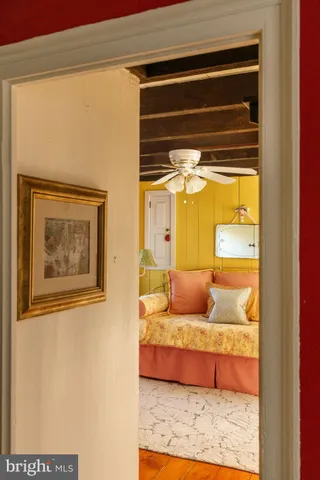 a living room with a couch and chandelier