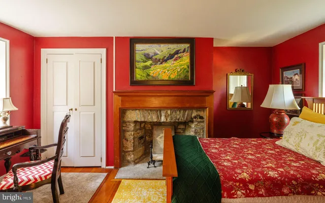 a bedroom with a bed and a fireplace