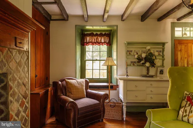 a living room with furniture a window and wooden floor
