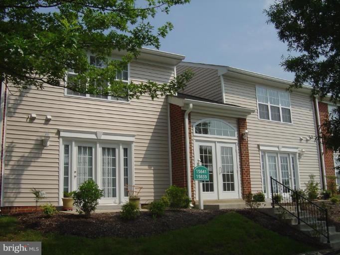 15653 Horseshoe Lane, Unit 653 Woodbridge, VA 22191 - Photo 1 of 7 a front view of a house with a yard and plants