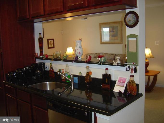 15653 Horseshoe Lane, Unit 653 Woodbridge, VA 22191 - Photo 4 of 7 a kitchen with a sink and cabinets