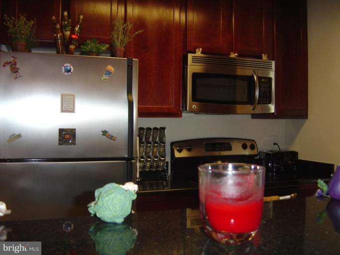 15653 Horseshoe Lane, Unit 653 Woodbridge, VA 22191 - Photo 5 of 7 a kitchen with cabinets and appliances